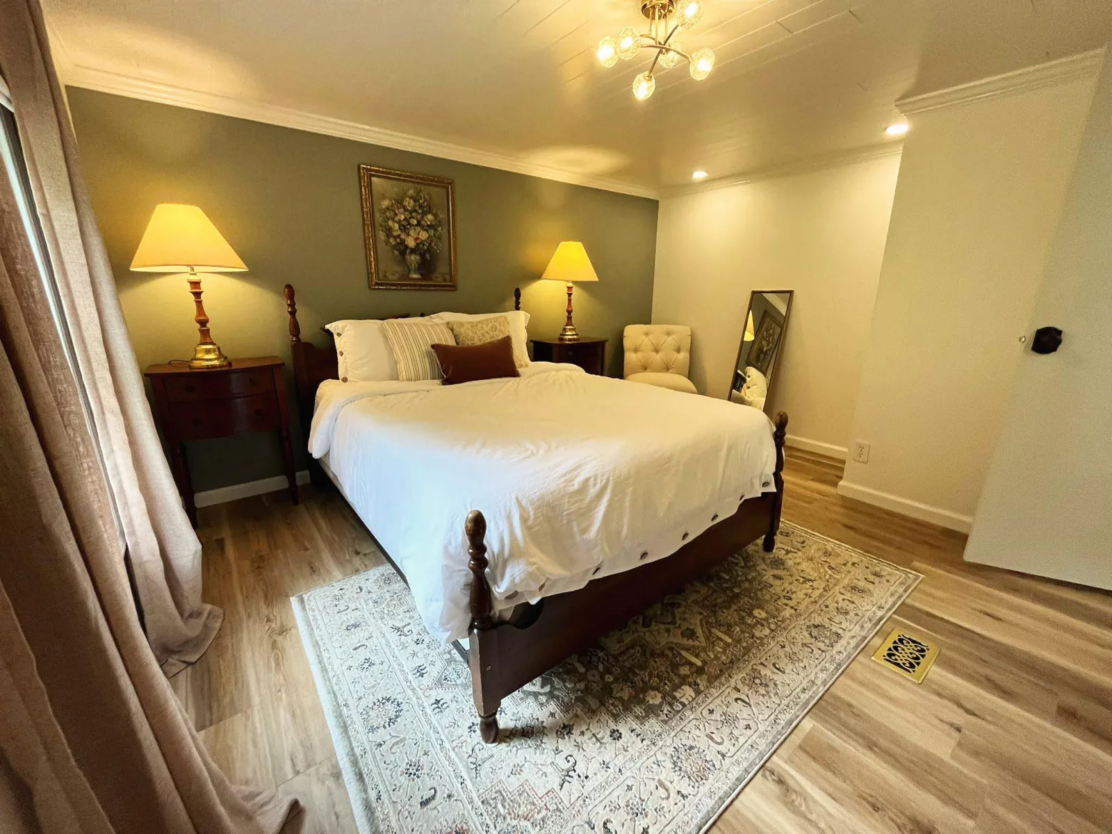 Dark green paneled accent wall with warm sconces and framed art